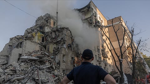 A man looks at a residential building damaged following a Russian air attack on the Ukrainian capital of Kyiv on July 2, 2026, amid the Russian invasion in Ukraine.