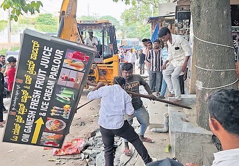 GBA workers remove signboards from a footpath to clear way for pedestrians 
in Thanisandra on Thursday 