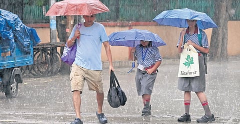Children brave rain on Thursday, as monsoon showers lashed city 