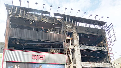 Firefighters at the site after a fire broke out at an electronics showroom at Janakpuri, in New Delhi, early Wednesday, July 1, 2026. 