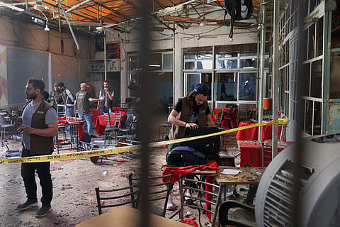 Syrian security inspects the site after an explosive device was detonated in a cafe near the main courthouse complex, in Damascus, Syria, Thursday, July 2, 2026.