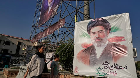 People walk past banners showing portraits of the Iranian Supreme Leader Ayatollah Mojtaba Khamenei in downtown Tehran, Iran, Monday, June 29, 2026. 