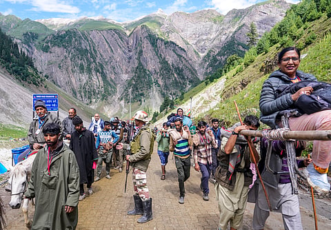  A security officer keeps vigil as the first batch of Amarnath Yatra pilgrims proceeds towards the holy cave shrine via the Baltal route, in Ganderbal district of Jammu and Kashmir, Friday, July 3, 2026.
