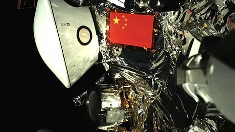 A photo taken by Tianwen-2 of itself with Earth in the background. 