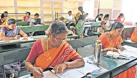 Teachers appear for TET at an exam centre in Tiruchy on Saturday.