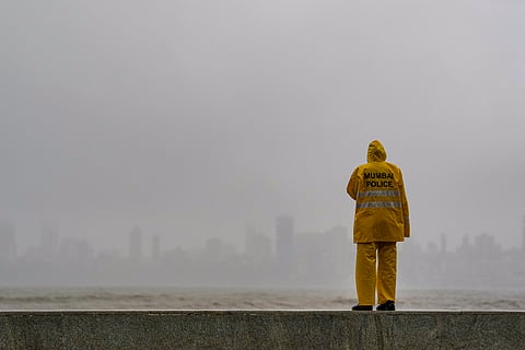 A police official on a rainy day at Marine Drive, in Mumbai, Maharashtra, Friday, July 3, 2026. 