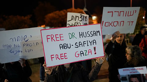 A woman holds a sign that reads "Free Dr. Hussam Abu Safiya, Free Gaza" during a protest in front of the Shin Bet offices, calling for his release, in Tel Aviv, Israel, on Jan. 1, 2025.