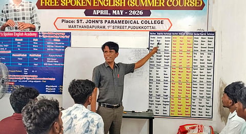 P Anthony teaching spoken English to a class of young learners during summer vacation at a college in Pudukottai.