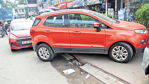 Bike and car parking, garbage dumping, shop extensions, tea stalls, random construction material, and even police barricades have taken over pedestrian spaces. 
