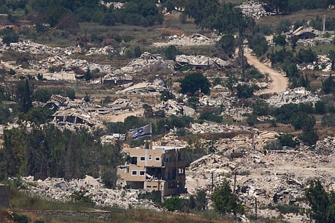 An Israeli flag hangs on a damaged building in southern Lebanon as seen from northern Israel on Wednesday, July 1, 2026. 