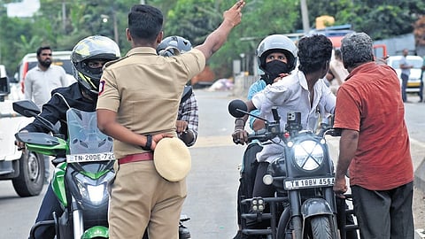 Police personnel preventing the commuters from coming  near the unit; the shuttered shops in 
the area.