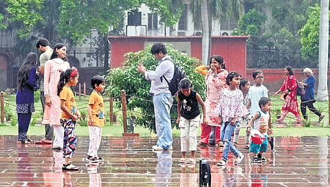 A family enjoys the rainy weather during an outing on Sunday evening.