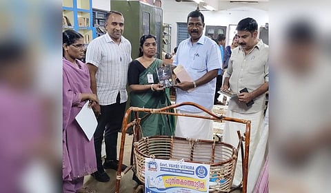 Aruvikkara MLA G Steephen contributing a book to the Book Cradle initiative.
