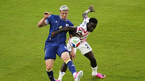 United States' Folarin Balogun fouls Bosnia's Tarik Muharemovic, resulting in a red card go Balogur on Wednesday