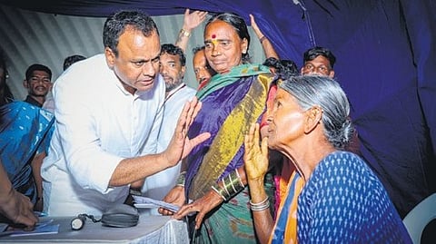 Munugode MLA Komatireddy Rajgopal Reddy interacts with an elderly woman during an eye camp at Choutuppal.