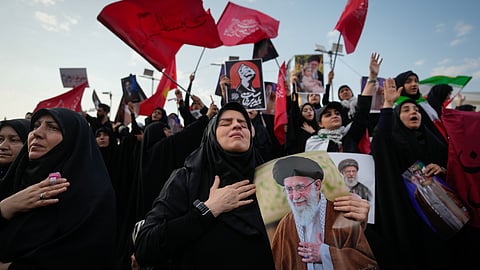 A mourner reacts while holding a portrait of the slain Iranian Supreme Leader Ayatollah Ali Khamenei as mourners gather in Islamic Revolution Square for Khamenei's funeral procession in Tehran, Iran, Monday, July 6, 2026