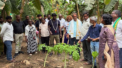 Wanjama Njoroge Daniel, Coordinator of the Seed Saver Network, Kenya, leads a delegation during a visit to Natural Farming fields in Eluru district.