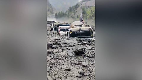 Vehicles are seen partially buried amid mud and boulders washed along the rain-triggered flash floods, in Kishtwar district, Jammu and Kashmir.