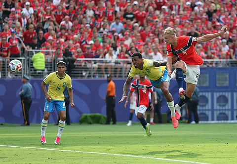 Erling Haaland (R) scores the opening goal against Brazil on Sunday
