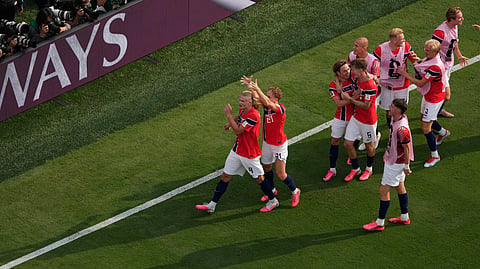 Norway’s Andreas Schjelderup (21) crowns Erling Haaland (9) as others celebrate after Haaland scored their second goal during the World Cup round of 16 soccer match between Brazil and Norway in East Rutherford, N.J., near New York, Sunday, July 5, 2026. 