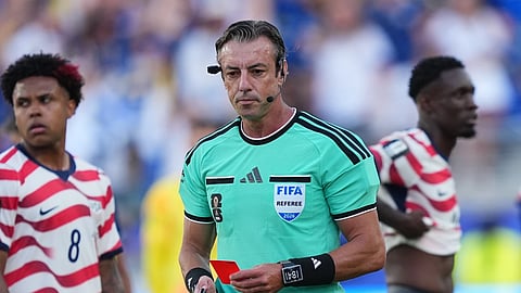 United States' Folarin Balogun, right, stands by after being issued a red card by Referee Raphael Claus, of Brazil, centre, as the United States' Weston McKennie (8) looks on during the World Cup round of 32 soccer match between the United States and Bosnia in Santa Clara, Calif., Wednesday, July 1, 2026. 