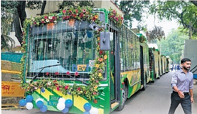 Workers decorate a Delhi Electric Vehicle Interconnector (DEVi) bus on the day of its inauguration and flagging-off by Union Home Minister Amit Shah, unseen, at RK Puram in New Delhi, Tuesday, July 7, 2026.