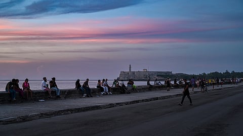 People gather along the Malecon during a nationwide blackout in Havana on July 6, 2026.