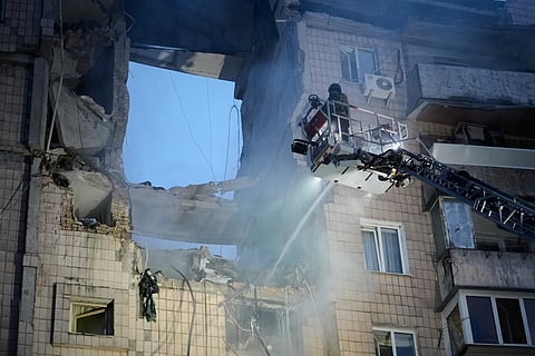 Rescuers work the scene of a building damaged by Russian missile attack in Kyiv, Ukraine, Monday, July 6, 2026.