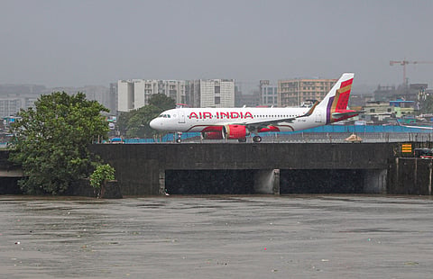 An airplane prepares to take off amid rain, near Mithi river in Mumbai, Monday, July 6, 2026. India Meteorological Department (IMD) issued a 'red' alert for Mumbai, forecasting heavy to very heavy rainfall accompanied by strong winds. 