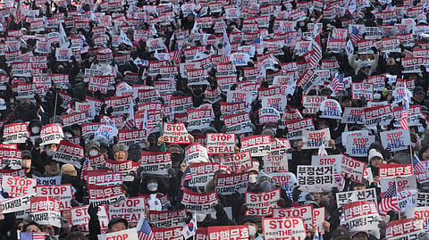 Supporters of impeached South Korean President Yoon Suk Yeol stage a rally to oppose his impeachment in Seoul, South Korea, Jan. 11, 2025. The letters read, "Impeachment is invalid."