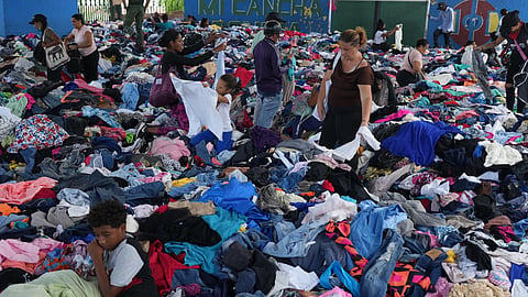 People choose clothes donated to those affected by the earthquakes at a sports complex in La Guaira, Venezuela, Saturday, July 4, 2026.