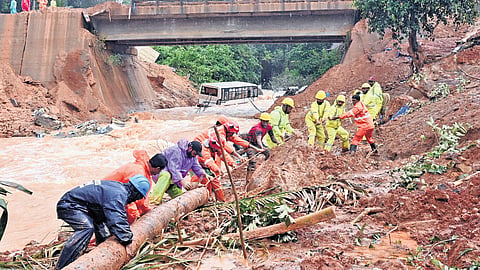 Fire force personnel clearing the debris along the riverbank as search for the missing persons continues at the landslip-site at Kalladi in Wayanad on Wednesday 