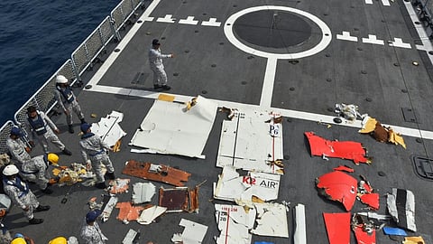In this photo released by Pakistan Navy, Pakistan Navy personnel examine the wreckage of a cargo plane of the private carrier K2 Airways on a naval ship after recovering them from deep sea near Omara, a town some 360 kms. (220 miles) west of Karachi, Pakistan, Wednesday, July 8, 2026. 
