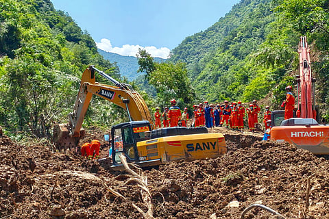 In this photo released by Xinhua News Agency, rescuers conduct search and rescue at the site of a landslide at a village in Nanhe township of Tanchang County, Longnan City, northwest China's Gansu Province on Tuesday, July 7, 2026. 
