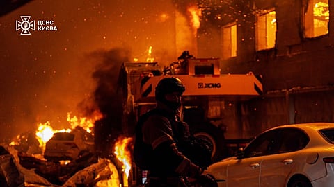 In this photo provided by the Ukrainian Emergency Service, emergency services personnel work to extinguish a fire following a Russian air attack in Kyiv, Ukraine, Wednesday, July 8, 2026.