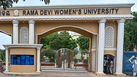 Students shut the main gate protesting entry of outsiders and a political banner installed near the campus of Ramdevi Womens University in Bhubaneswar.