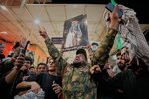 An Iraqi Shiite soldier chants on the eve of funeral ceremonies for the late Iranian Supreme Leader Ayatollah Ali Khamenei outside the Imam Ali Shrine in Najaf, Iraq, Tuesday, July 7, 2026.