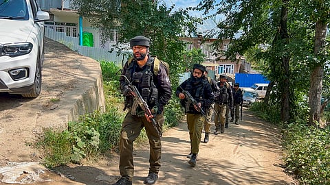 Security personnel keep vigil near the encounter site at Chanapora as the anti-terror operation enters its fifth day, in Shopian district, Jammu and Kashmir, Wednesday, July 8, 2026. 