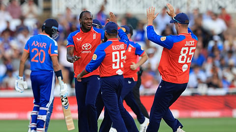 England's Jofra Archer celebrates with teammates after taking the wicket of India's Shreyas Iyer during the third Twenty20 (T20) international cricket match between England and India at Trent Bridge in Nottingham, central England on July 7, 2026. 