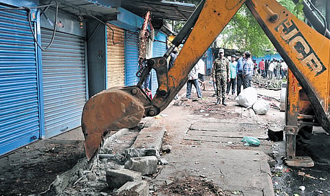 GBA workers clear footpath encroachments by shop owners at KR Market on Wednesday.