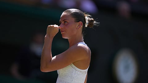 Marta Kostyuk of Ukraine celebrates a point against Jasmine Paolini of Italy, in their quarter-final women's singles match at the Wimbledon Tennis Championships in London, Wednesday, July 8, 2026.