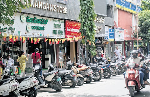 Commercial establishments operate along DVG Road despite repeated notices and warnings.