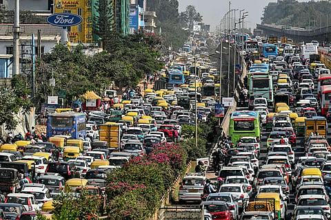 Commuters stuck in a gridlock along a road leading to the Yelahanka Air Force Station in Bengaluru