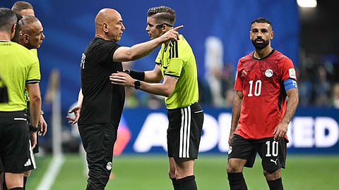 Egypt coach Hossam Hassan in conversation with French referee Francois Letexier