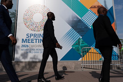 Delegates walk to the entrance of the International Monetary Fund (IMF) headquarters during the World Bank/IMF Spring Meetings at the IMF headquarters in Washington, April 15, 2026. 
