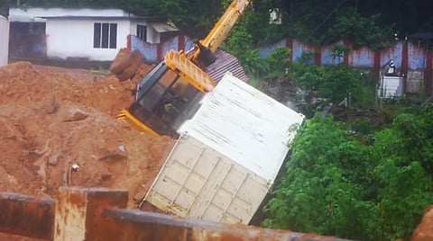 An excavator remains partially buried under debris at the site of the landslide that struck the under-construction Anakkampoyil-Kalladi-Meppadi twin tunnel project, in Wayanad district, Thursday, July 9, 2026. Rescue operations continued for the third consecutive day following the incident. 