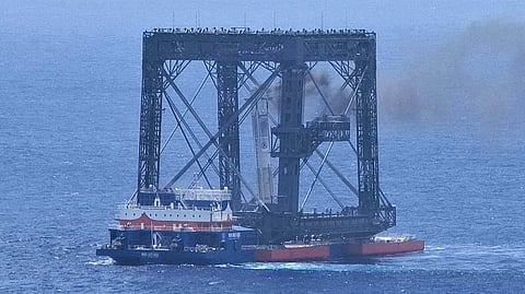 In this photo released by Xinhua News Agency, a drone photo shows the successful capture of the returned first stage of Long March-10B carrier rocket on a seaborne platform via a net-capture system near Wenchang in southern China's Hainan province on Friday, July 10, 2026.