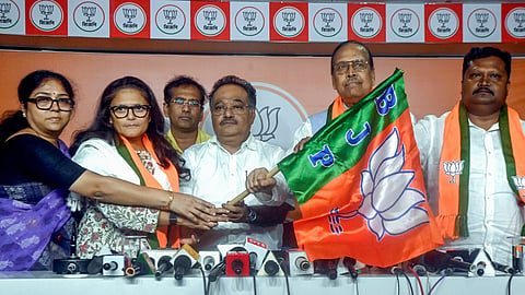  West Bengal BJP President Samik Bhattacharya holds the party's flag as a celebration as former Trinamool Congress MPs Sushmita Dev, Sukhendu Sekhar Roy, and Prakash Chik Baraik join BJP, in Kolkata on July 9, 2026. 