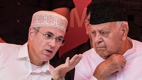 Jammu & Kashmir Chief Minister Omar Abdullah, left, interacts with Jammu & Kashmir National Conference (JKNC) President Farooq Abdullah