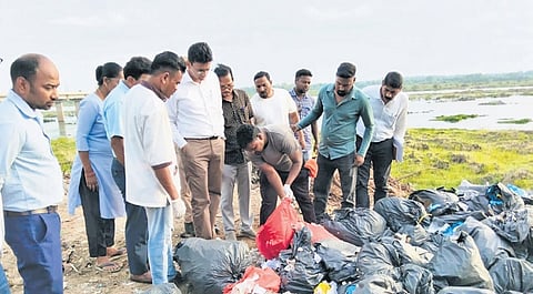 SMC staff inspecting the biomedical waste dumped near Mahanadi immersion pond